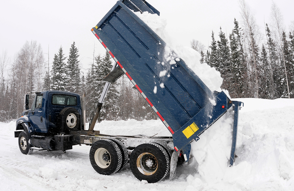 Snow int a tandem truck at an Edmonton commercial property